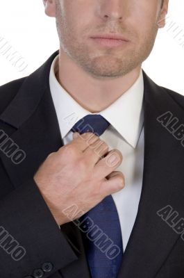 young businessman fastening his tie