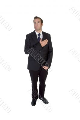 standing businessman saluting by heart