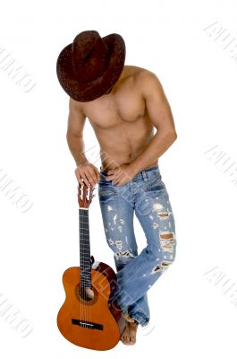 man in cowbow hat holding guitar