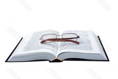 glasses on the opened book