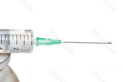 Drop on a syringe needle.