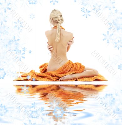 lady with orange towels on white sand