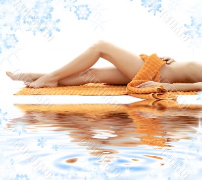 long legs of relaxed lady with orange towel