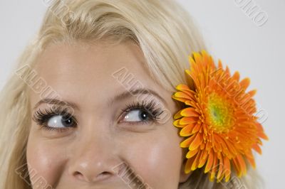 lady with flower in hair looking askance
