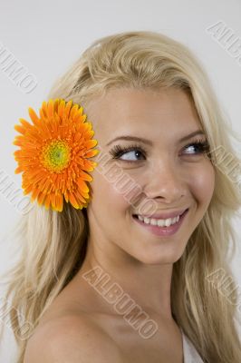 woman with orange gerbera