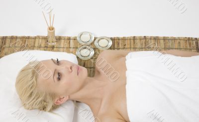 woman lying on massage mat