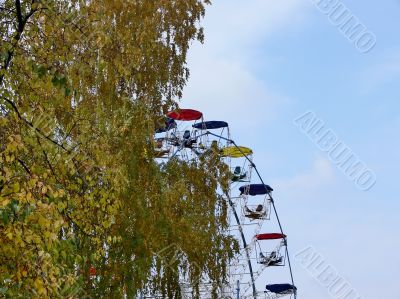 Big wheel, yellow tree and the blue sky