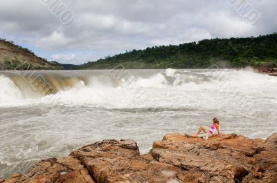 Woman with waterfall in background