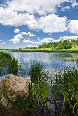 River under blue sky with clouds