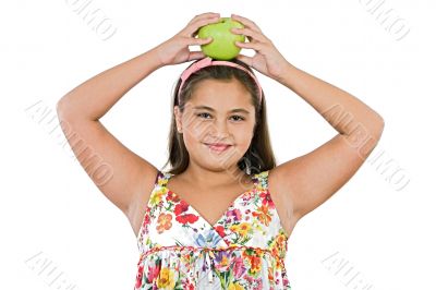 Adorable girl with flowered dress with a apple