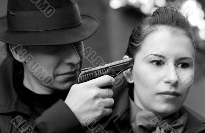 man threatens the woman with a pistol