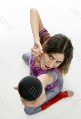 woman showing microphone into camera