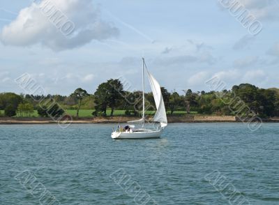 Sailing vessel on an ocean gulf in the afternoon 
