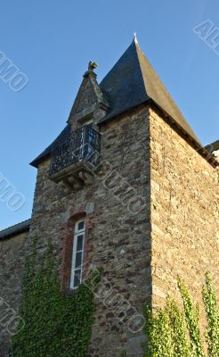 Ancient castle tower in France, shined on the one hand the sun

