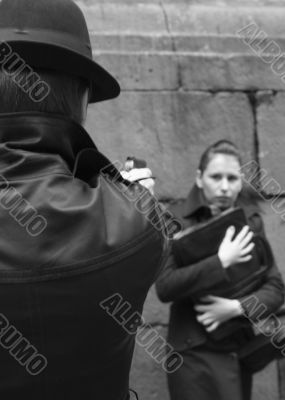 man threatens the woman with a pistol