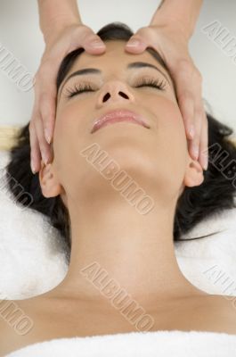 young pretty woman getting head massage