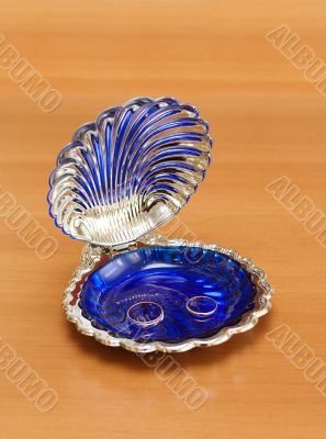 Gold wedding rings in a shell