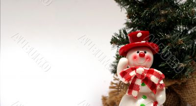 Christmas card with a snowman and christmas-tree