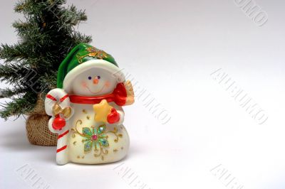 Christmas card with a snowman and christmas-tree