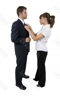 woman holding tie of man