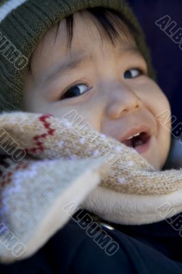 small child with scarf and hood