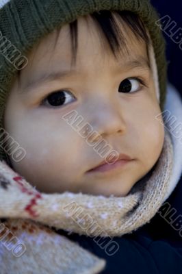 small child with scarf and hood