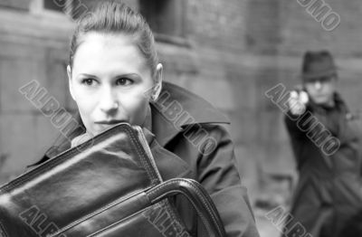 man threatens the woman with a pistol