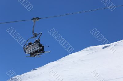 Chair lift at ski resort. Winter vacations