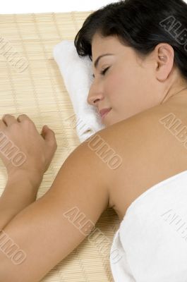 female sleeping on bamboo mat