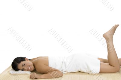pleased woman laying on bamboo mat