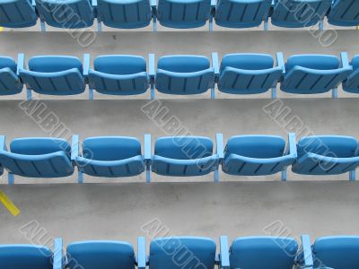 blue aligned plastic chairs
