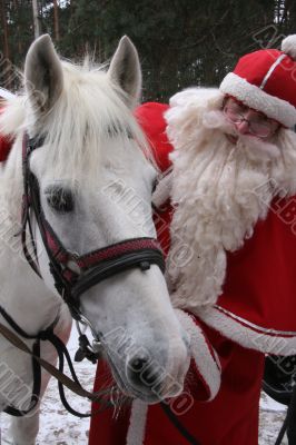  	Santa Claus holds white horse