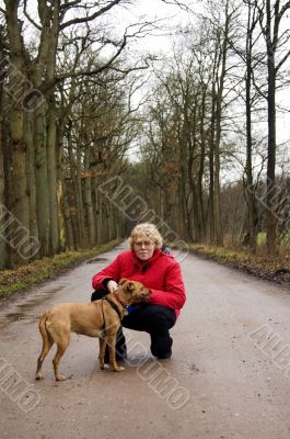 elderly woman together with the dog in a park