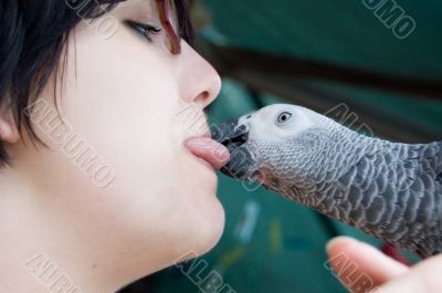 young woman holding a grey parrot
