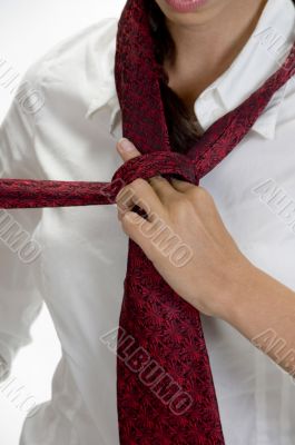 young pretty woman tying her tie
