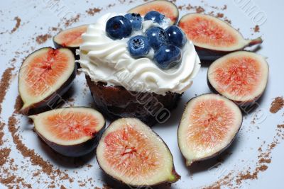 One blueberry cake surrounded with figs