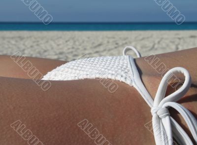 female in a white bikini on the beach