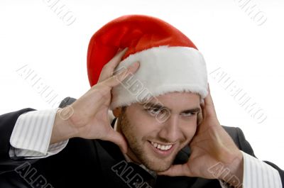 man posing with santa cap and holding his face