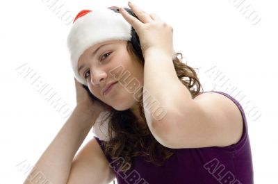 teenager with santa hat and listening to music