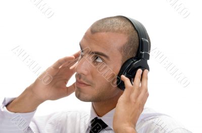 man holding earphone and looking upward