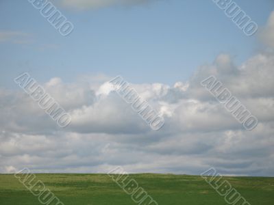 green valley and cloudy sky