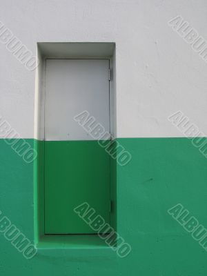door on a white and green building