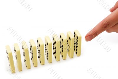 The finger pushes a dominoe