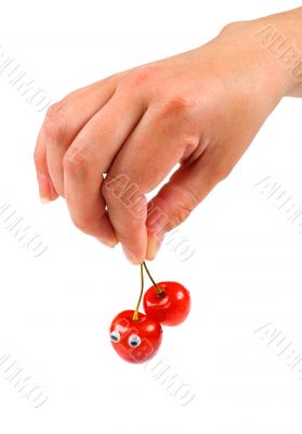 Hand holding two sweet cherry