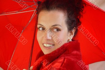 Attractive middleage woman with red umbrella