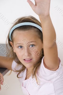 sweet little girl raising her hand