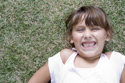 laying girl with clenched teeth