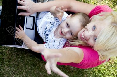 mother and child working together on laptop