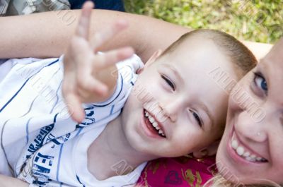 happy mother and child posing towards camera
