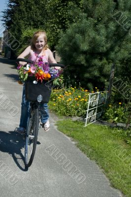 Girl on a bike with flowers